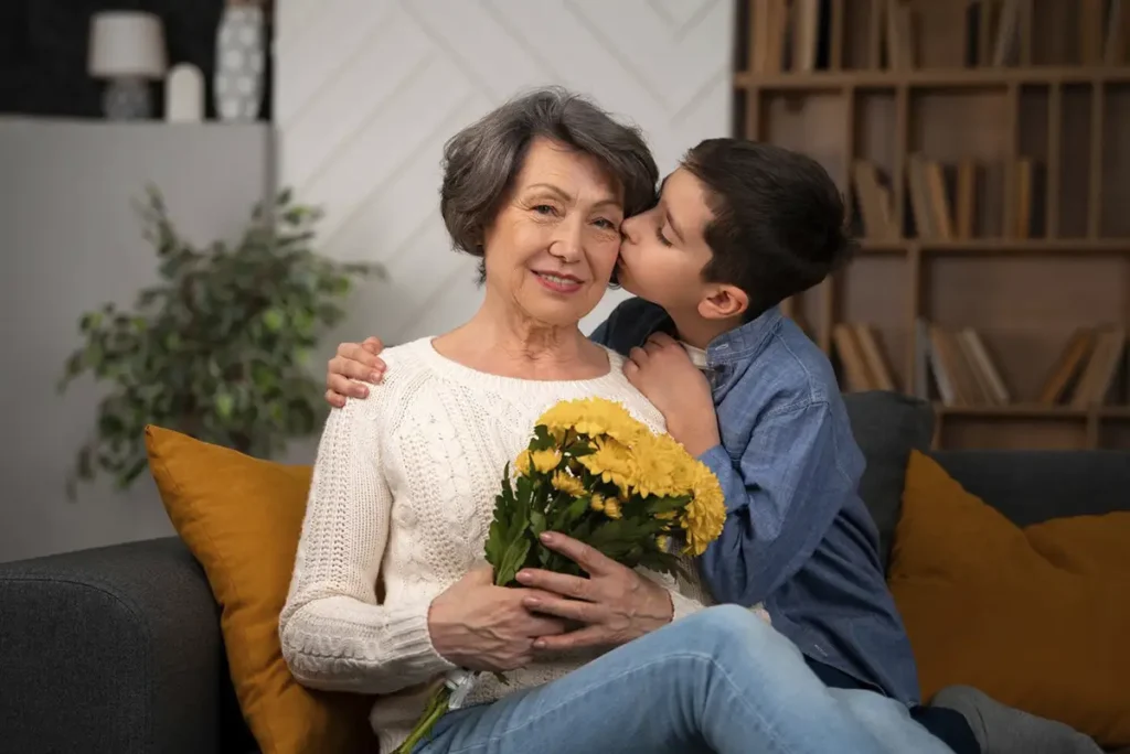 Son giving flowers on her mother to celebrate Mother's Day